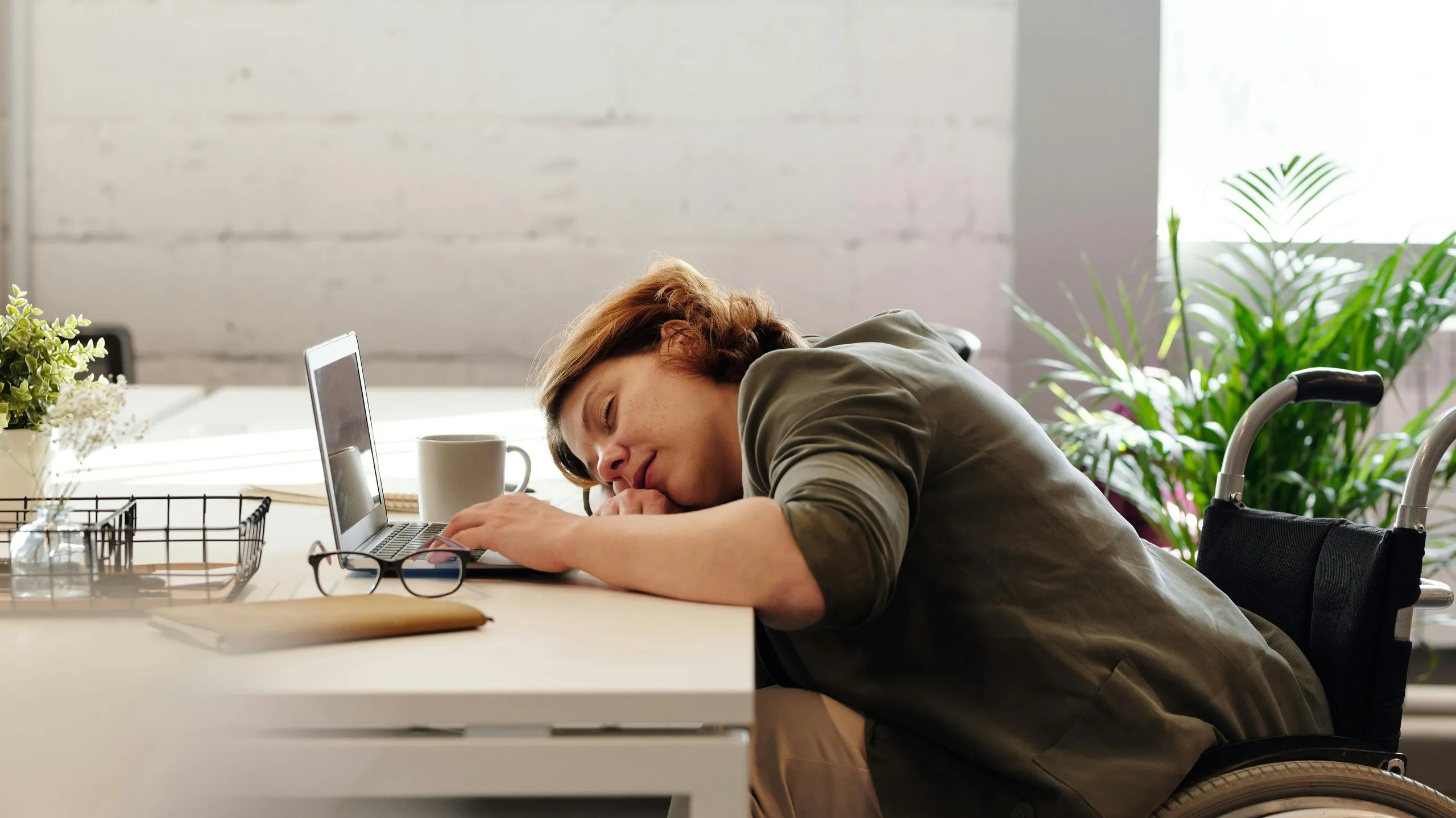 A businesswoman leans on her desk after long hours, reflecting on whether her digital marketing strategy is delivering real results.