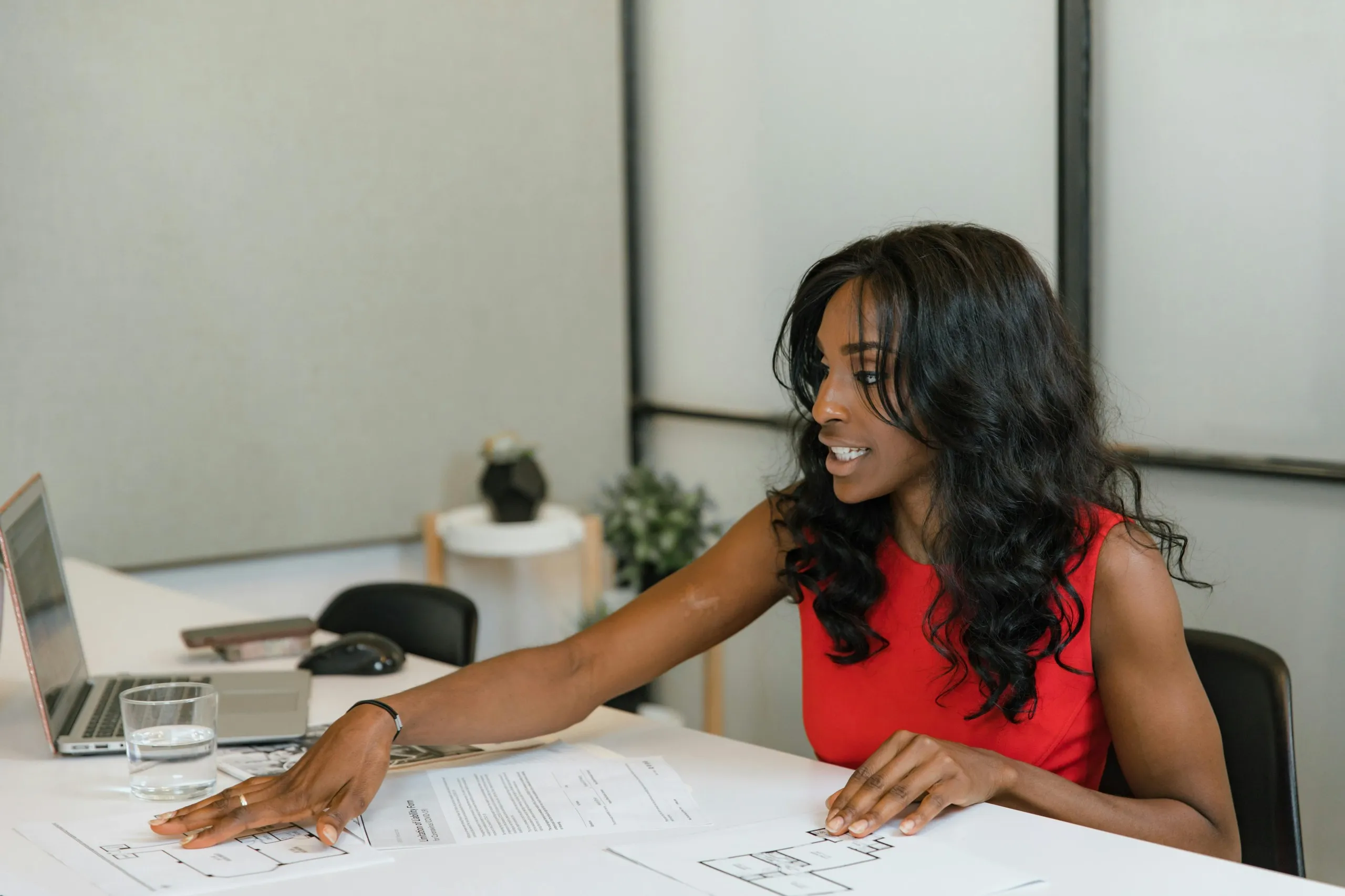 Focused professional seated at a clean desk in a modern office, portraying a professional executive-level administrative support managing responsibilities with precision.