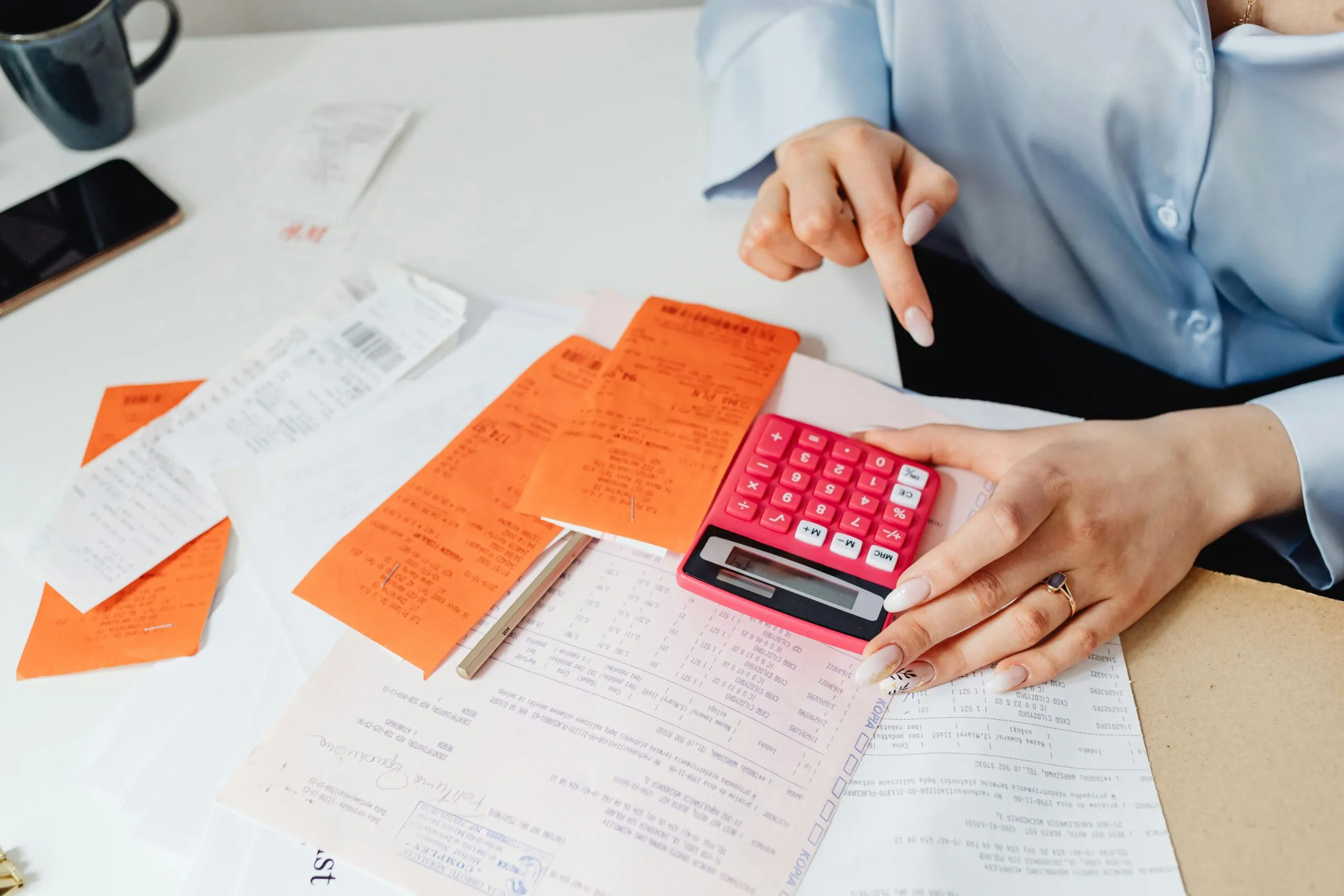 Business owner reviewing financial reports prepared by a bookkeeper, symbolizing Timber Creek Virtual’s role in providing accuracy and business advantages through expert bookkeeping.